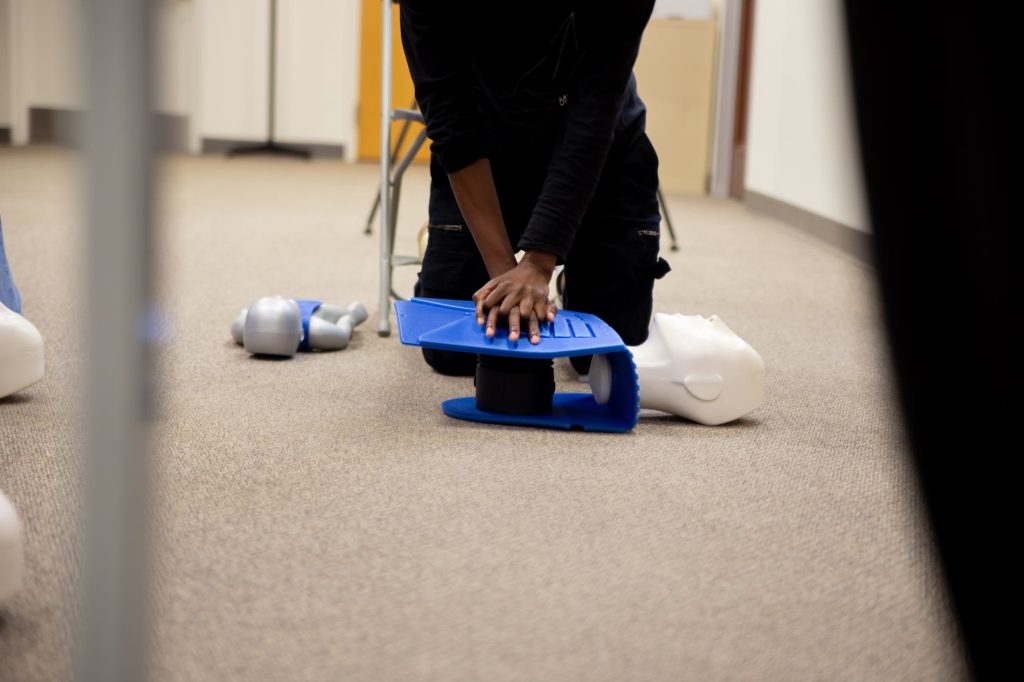 a person performing cpr on a dummy